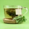 clear glass mug with green leaves